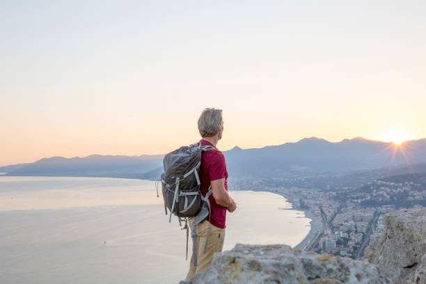istock Hiker relaxes on coastal mountain at sunrise 1264362292
