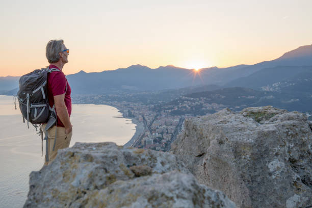 istock Hiker relaxes on coastal mountain at sunrise 1264362324