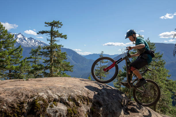 istock Mountain biker rides up mountain ridge 1264363142