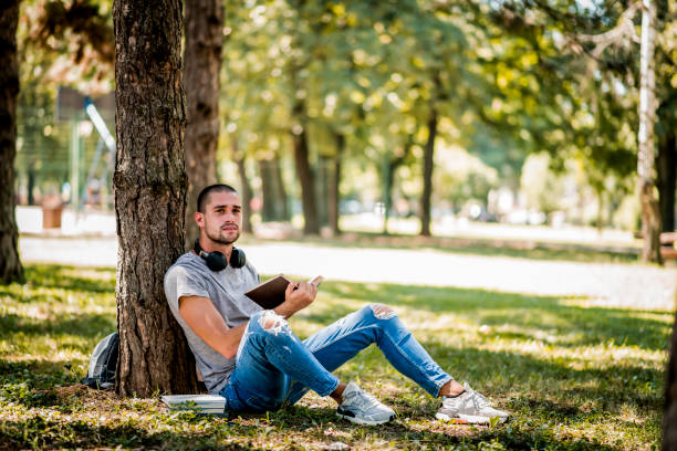 istock Man studying in the city park during the weekend 1264363153