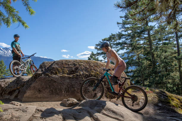 istock Mountain bikers ride along mountain ridge 1264363452