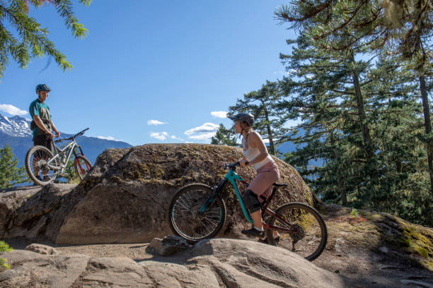 istock Mountain bikers ride along mountain ridge 1264364003