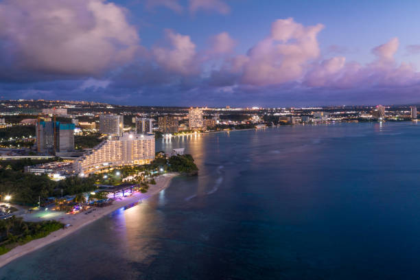 Tumon Bay at Dusk An aerial view of Tumon Bay in Guam at dusk. Tumon is the tourist destination of Guam. guam stock pictures, royalty-free photos & images