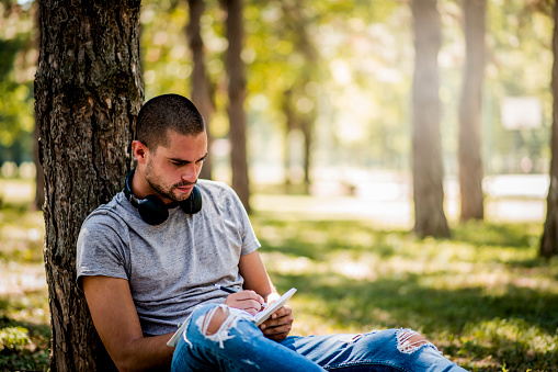 Man studying in the city park during the weekend