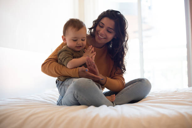 istock Mother playing with her baby at home 1264366168