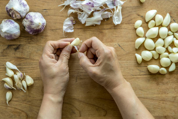 istock Peeling a clove of garlic. 1264366794