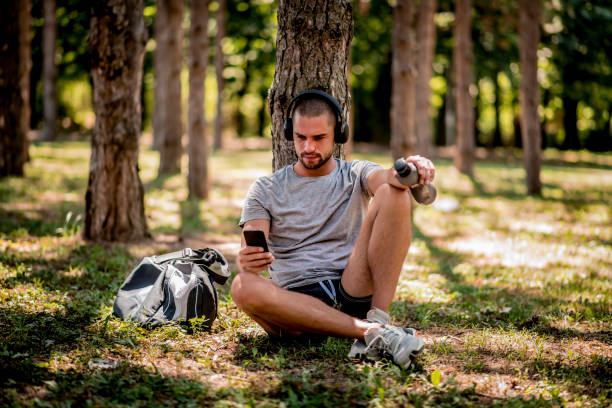 istock Young man is resting in the park after run 1264366965