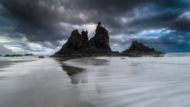 istock Waves flowing on the beach in Spain with rocks 1264368873