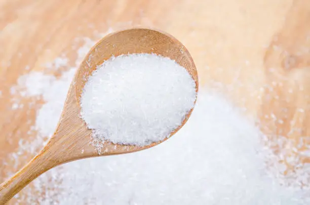 Monosodium glutamate (MSG) in wooden spoon, a flavor enhancer in many asian food
