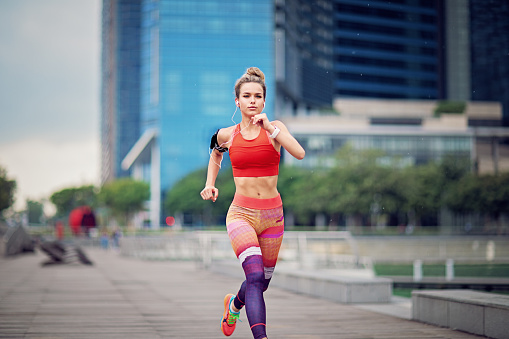 Young woman is running in the city