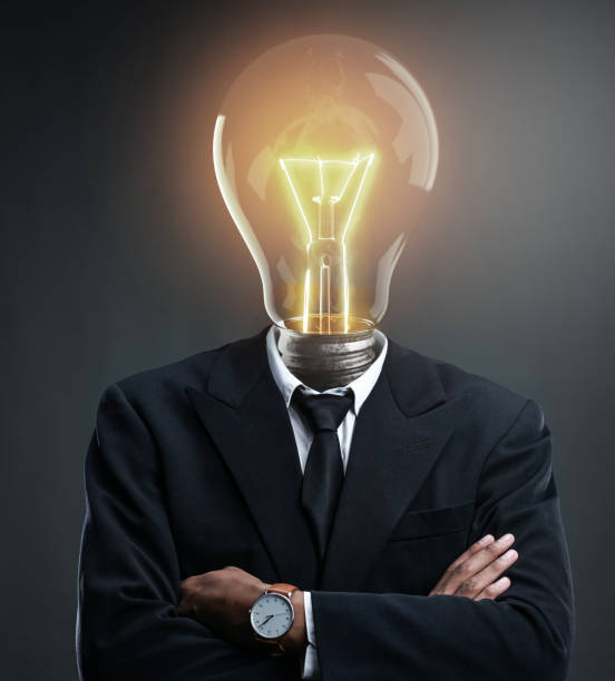 istock Businessman with Glowing Light Bulb Head Concept. Brilliant Idea Concept 1264375197