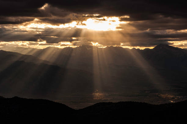 istock Crepuscular Rays and Sunset thru the clouds from the White Mountains looking toward the Sierra Nevada Mountains in California, Sun rays 1264375918