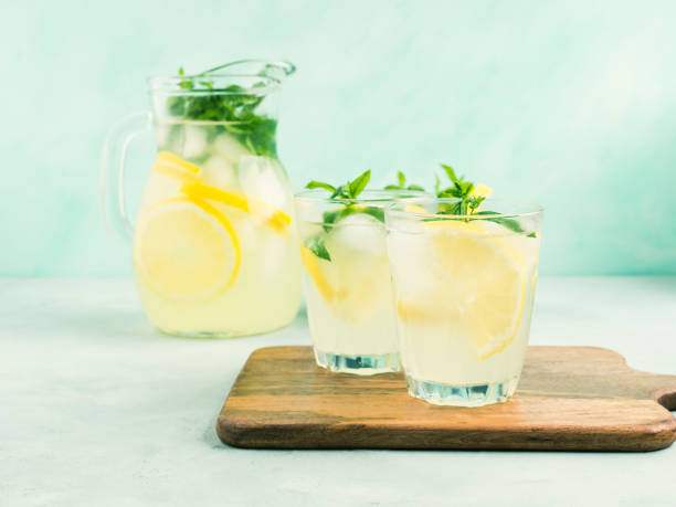 istock Fresh lemon lemonade in jug and glasses 1264378619
