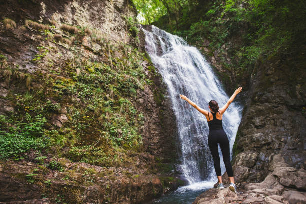Free Stock Photo of Woman Standing on Cliff Looking at Waterfall ...