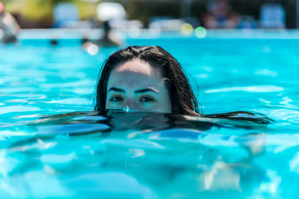 istock Young woman swimming in the pool 1264378865
