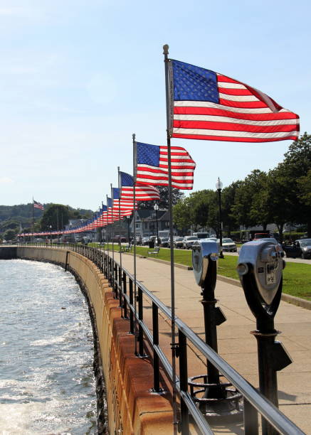 Flags-lined embankment of the Western Harbor at Stacy Blvd, Gloucester, Massachusetts stock photo