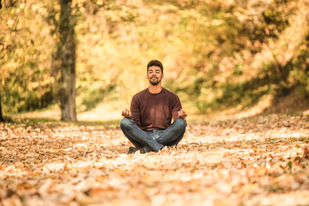 istock Young man taking a break in nature and meditating. 1264385844