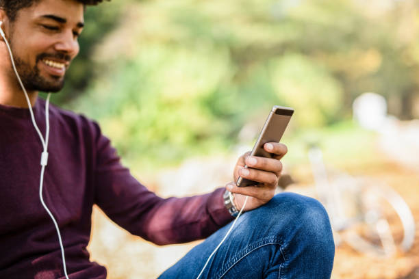 istock Happy young man using a phone and listening to music. 1264386151
