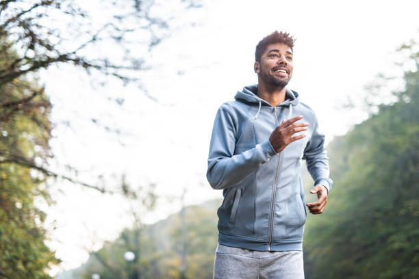 istock Happy African American man running in nature. 1264386172