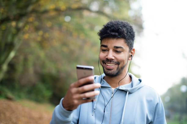 istock Happy African American man using phone in nature. 1264387501