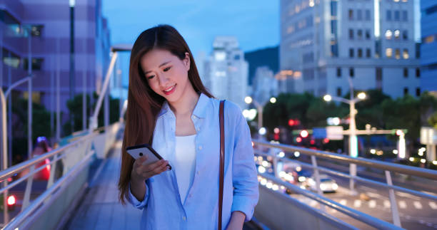 istock woman use smartphone outdoor 1264394780