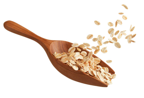scoop of oatmeal splash - oatmeal rolled oats oat raw imagens e fotografias de stock