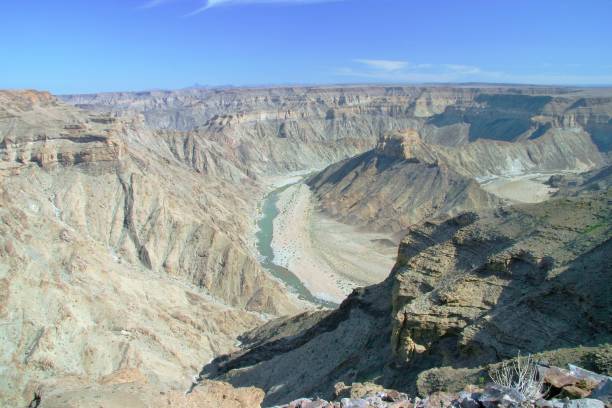 Panoramic View of The Fish River Canyon in Namibia It is a giant ravine, in total about 100 miles (160 km) long, up to 17 miles (27 km) wide and in places almost 1800 feet (550 meters) deep. barron gorge national park stock pictures, royalty-free photos & images