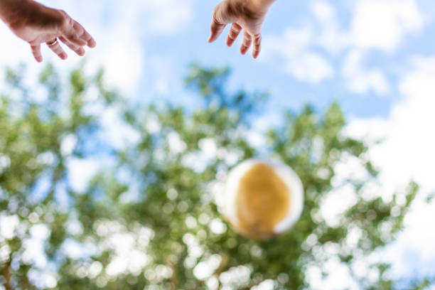 In Western Colorado Human Hands Reaching in the Air Outdoors Toward the Sky a Large Rubber Ball (Shot with Canon 5DS 50.6mp photos professionally retouched - Lightroom / Photoshop - original size 5792 x 8688 downsampled as needed for clarity and select focus used for dramatic effect)