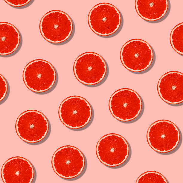 istock Seamless grapefruit with shadow pattern on pastel surface. Colorful fresh citrus slice pink pattern. 1264402326