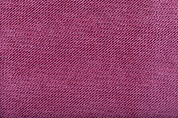 close-up of pink fabric surface, small stitches as background stock photo