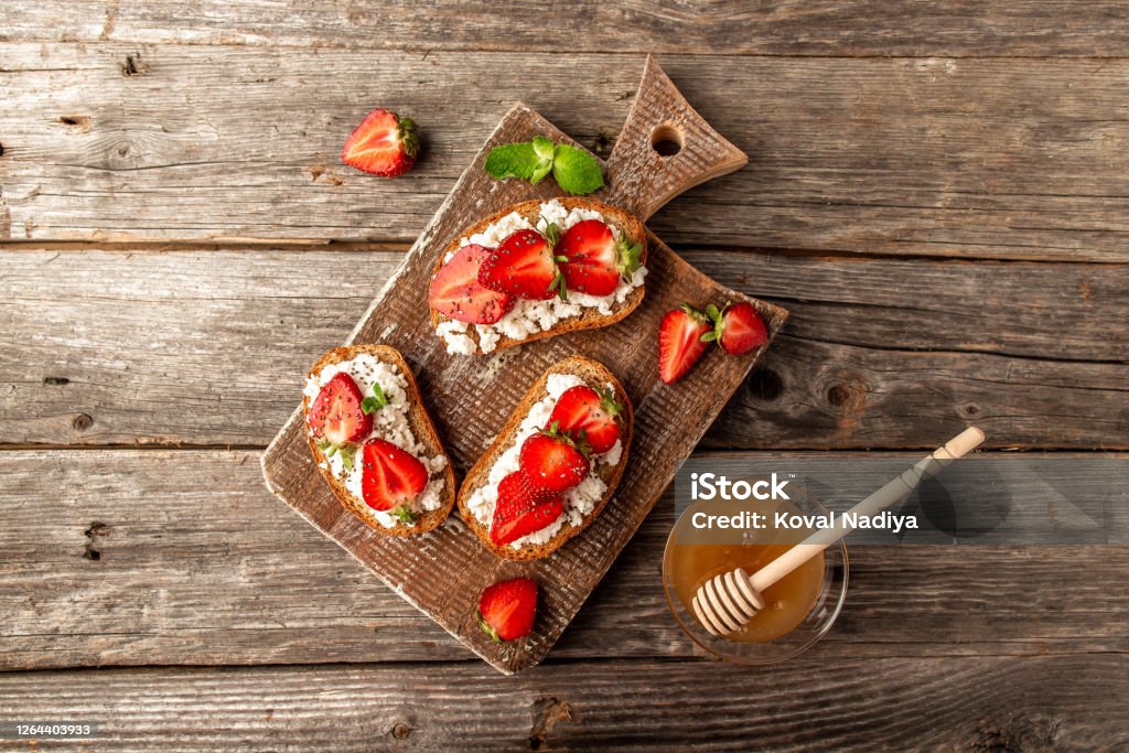 Strawberry bruschetta with goat cheese, banner, catering menu recipe place for text, top view Strawberry bruschetta with goat cheese,basil and balsamic vinegar Strawberry Stock Photo