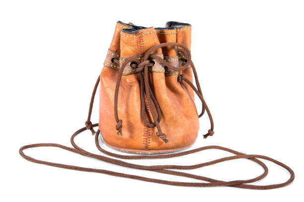 istock Leather drawstring bag with string tied the knot isolated on white background. Old brown leather drawstring pouch bag isolated 1264408086