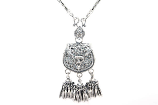 istock Silver pendant necklace bag design pattern isolated on white background. Silver necklace decoration with pouch carving flowers pattern and bead chain 1264410512