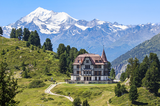 Riederalp, Switzerland - 05. August 2020: The Pro Nature Center for the Great Aletsch Glacier region - the Villa Cassel in summer. The building was built in 1902 in Victorian architecture style. Sir Winston Churchill was once a hotel guest there.