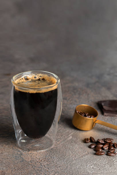 istock Americano coffee glass cup and coffee beans on concrete background. 1264415231
