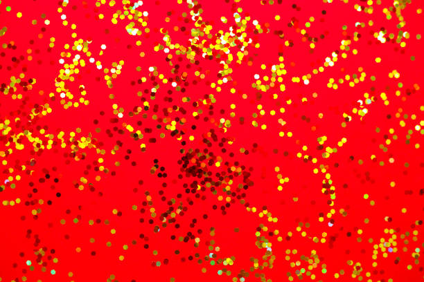 istock yellow and red sparkles on a red background 1264421274