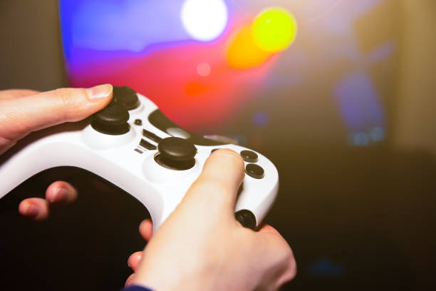 istock Man is playing video games at home. Gamepad in hands. Self isolation time. Entertainment during the quarantine period. 1264423952