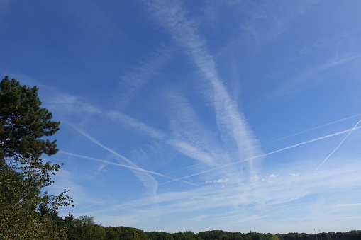Airplane contrails in the sky  Roissy-en-France region   Summer season