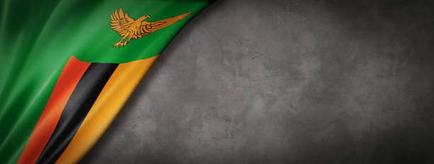 Zambian flag on concrete wall banner Zambia flag on concrete wall. Horizontal panoramic banner. zambia flag stock pictures, royalty-free photos & images