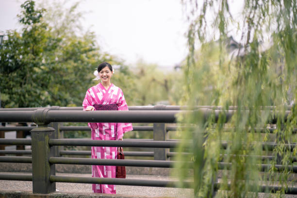istock Young woman in yukata standing on bridge in summer 1264431621