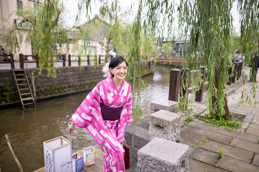 Young woman in yukata visiting old Japanese village for lantern festival