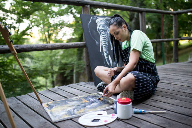 istock Creative woman painting on a canvas 1264433134