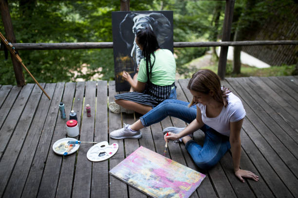 istock Two women painting in nature 1264434319