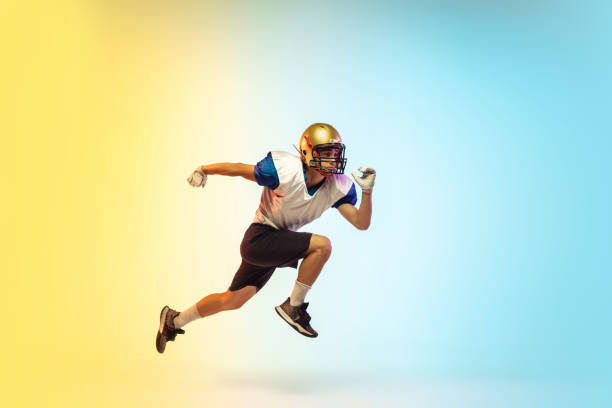 istock American football player isolated on gradient studio background in neon light 1264436169