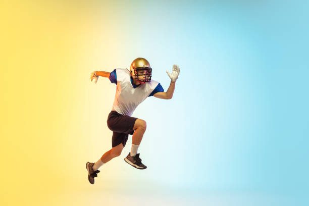 istock American football player isolated on gradient studio background in neon light 1264436172