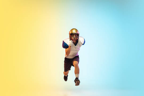 istock American football player isolated on gradient studio background in neon light 1264436173