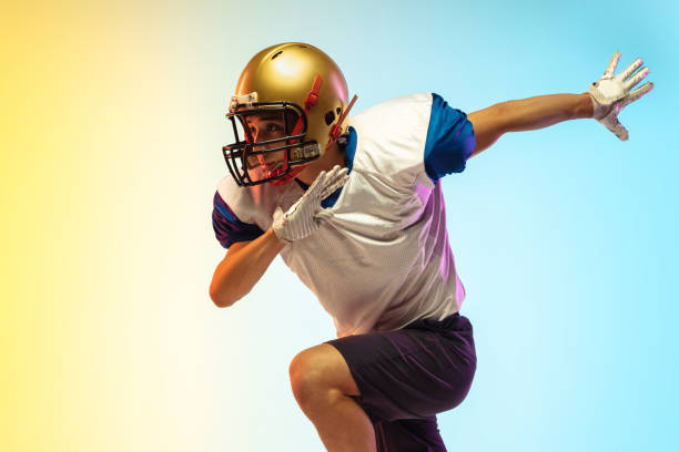 istock American football player isolated on gradient studio background in neon light 1264436175