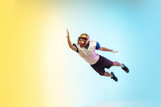 istock American football player isolated on gradient studio background in neon light 1264436177