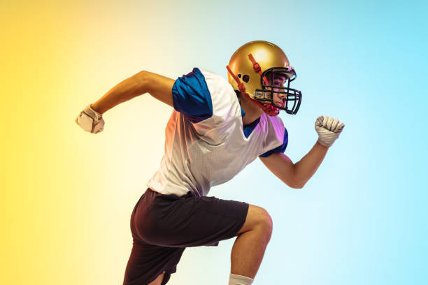 istock American football player isolated on gradient studio background in neon light 1264436179