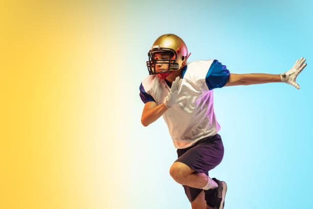 istock American football player isolated on gradient studio background in neon light 1264436186